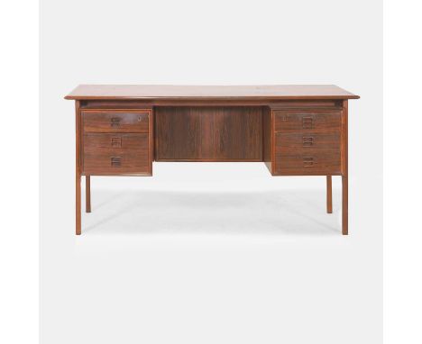 § Arne Vodder (Danish, 1926-2009), a rosewood desk, with an arrangement of drawers either side of a well, with shelves to the