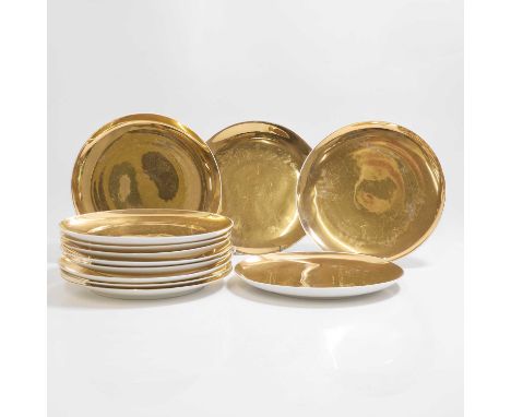 Piero Fornasetti (Italian, 1913-1988), a set of twelve plates, gilt, each with printed manufacturer's mark,each 26cm diameter