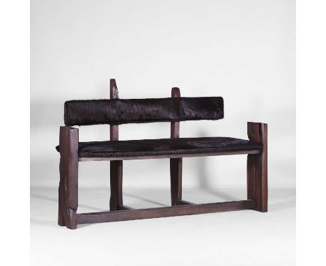 Brutalist, a stained wood bench, 1970s, French, the upholstery in dyed cowhide,162cm wide56cm deep100cm high