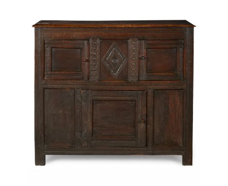 OAK LIVERY CUPBOARD  17TH CENTURY AND LATER   the lozenge carved centre panel enclosed by two fielded panel doors with single