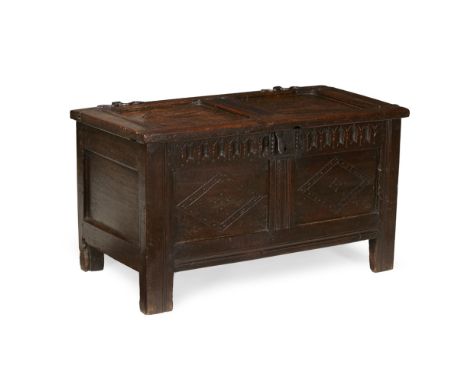 SMALL OAK COFFER  17TH CENTURY   the hinged top above a fluted frieze and double panel front with lozenge detail, raised on s