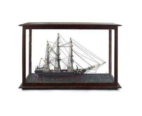 CASED MARINE IVORY MODEL OF A MERCHANT SHIP  19TH CENTURY   complete with three masts, rigging, life-boats, compass, and a pa