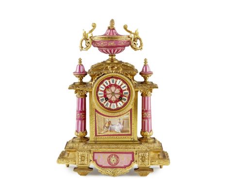 FRENCH GILT METAL AND PORCELAIN MANTEL CLOCK  19TH CENTURY   the circular mauve and pink ground porcelain dial with Roman num