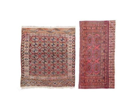 TEKKE RUG AND BAGFACE  TURKMENISTAN, EARLY 20TH CENTURY   the rug with four columns of seven guls, within starburst border; t