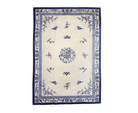 CHINESE CARPET    EARLY 20TH CENTURY    the plain cream field with central blue foliate and geometric medallion, foliate span