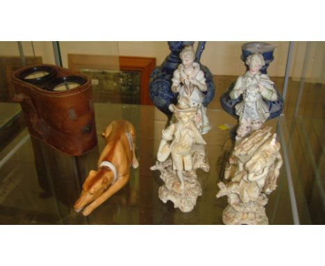 Shelf of decorative ornaments including continental bisque figures, salt glaze jug, greyhound ornament & opera glass