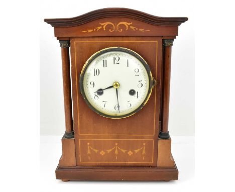 A late 19th/early 20th century mahogany mantel clock of architectural form with turned column sides, inlaid floral swags to t