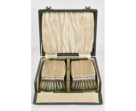 DEAKIN &amp; FRANCIS LTD; a cased pair of Eliabeth II hallmarked silver dressing table brushes, with matching hallmarked silv
