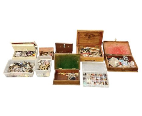 A large quantity of assorted costume jewellery including brooches, badges, tie pins, bangles, earrings, bracelets, necklaces 