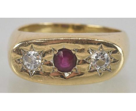 A 9ct gold ruby and diamond set ring, the flat table with star set central ruby flanked by two small brilliant cut diamonds, 