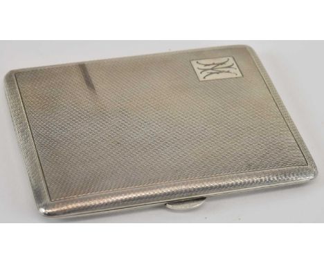A large hallmarked silver cigarette case, with all over engine turned decoration, the top left panel with the initials 'NI', 