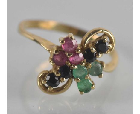 A yellow metal emerald, ruby and sapphire set multi-stone ring, set with three tiny emeralds, three tiny rubies and four tiny
