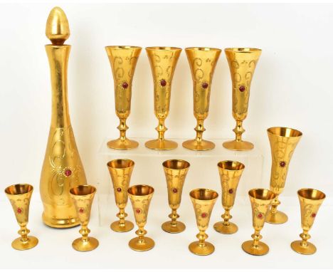 FLORES BAVARIA; a fifteen piece gilt covered glass decanter set, inset with red glass gemstones and comprising a tall slender