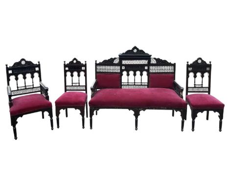 An Eastern four piece mother of pearl and bone inlaid salon suite comprising sofa, armchair and two bedroom chairs (4).