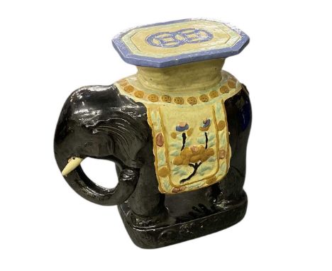 An early 20th century ceramic elephant garden seat, decorated with floral motifs, height 57cm.Condition Report: There are chi