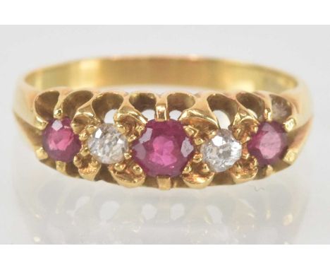 An 18ct yellow gold ruby and diamond set five stone ring, the central ruby approx 0.15ct, size L/M, approx 3.6g.