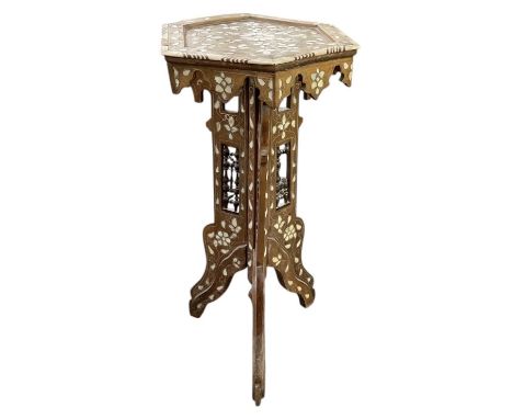 An Eastern profusely bone inlaid hexagonal topped tripod jardinière stand, height 67cm, diameter 33cm.