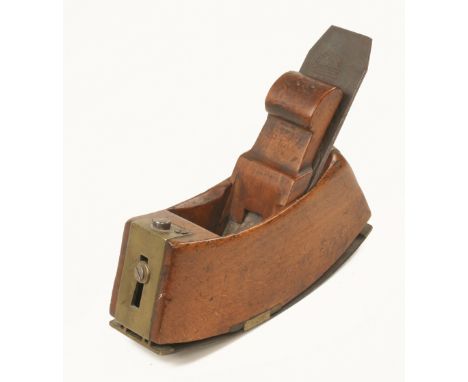 An unusual, nice quality adjustable beech compass plane with scrolled wedge, the steel sole adjusted by means of adjusting sc