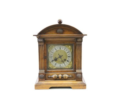 Bracket style Wooden cased Mantle clock with German Patent movement, the dial surrounded by winged Cherubs
