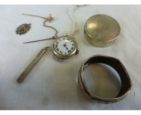 A circa 1920s/1930s circular silver wristwatch, a travelling white metal cased toothpick, a Victorian white metal pendant, a 