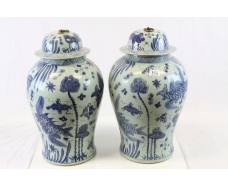 Large pair of Oriental ceramic blue & white Urns depicting Fish, with Brass Rings fitted to the lids