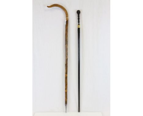 Wooden walking stick with a crook style handle and spike end plus Black finished vintage walking stick with a carved Oriental