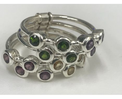 A silver four-ring ring with multi-stone set