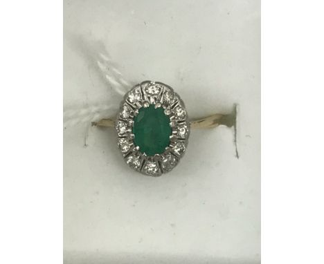 An 18ct emerald and diamond dress ring