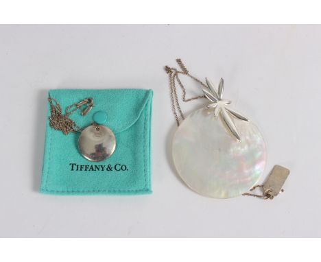 A Tiffany and Co. Elsa Peretti silver circular disc pendant on chain, in pouch and a mother-of-pearl and silver modernist pen