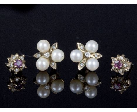 A pair of cultured pearl and diamond ear studs and a pair of diamond and ruby ear studs