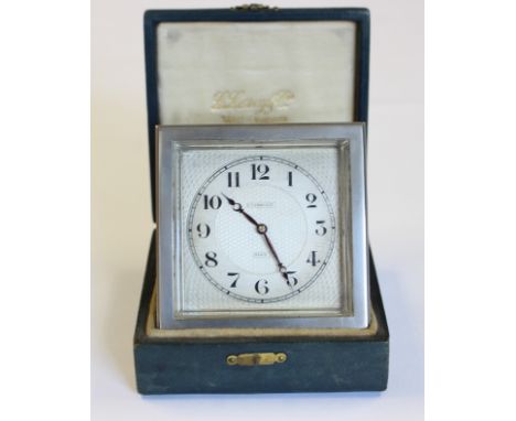 A French Art Deco desk clock, by L. Leroy & Co. Paris, with square face and engine-turned decoration, easel back, in fitted l