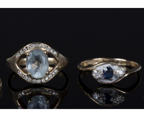 An aquamarine and diamond set ring to a gold mount, size 0½, a sapphire and diamond three-stone ring to an 18ct gold mount an