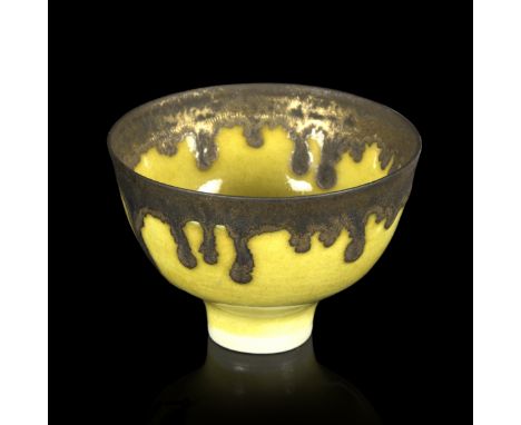 Dame Lucie Rie (Austrian/British 1902-1995)/Porcelain footed bowl with yellow glaze and bronzed manganese drip rim, impressed