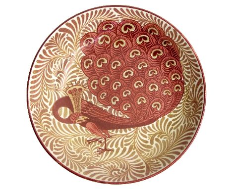 Charles Passenger for William de Morgan/Ruby and copper lustre dish/decorated a peacock in shades of ruby and scrolling coppe