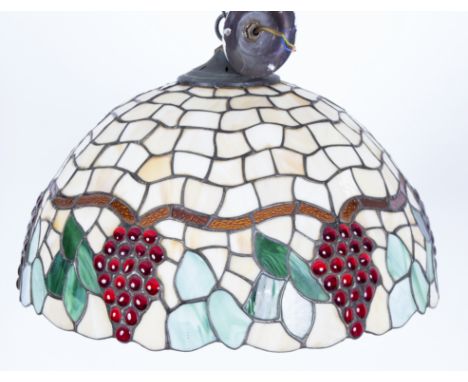 A Tiffany style pendant light fitting, the lead lined circular shade depicting fruiting vines, 51cm diameter