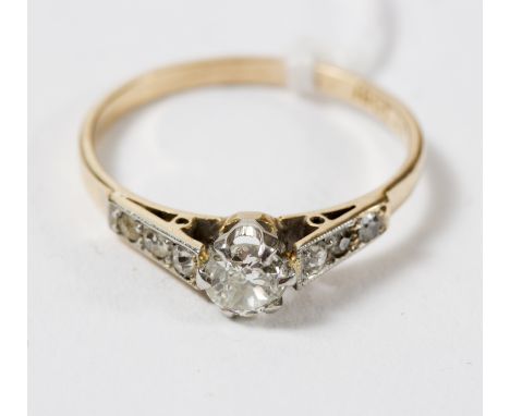 A diamond ring, the central old cut diamond approximately 0.5ct, with millegrain diamond set shoulders to an 18ct gold band, 