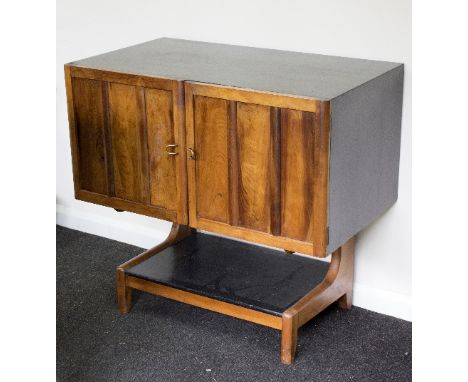 A mid-20th Century yew wood and black lacquer cocktail cabinet, with panel doors enclosing a shaped shelf, 91.5cm wide