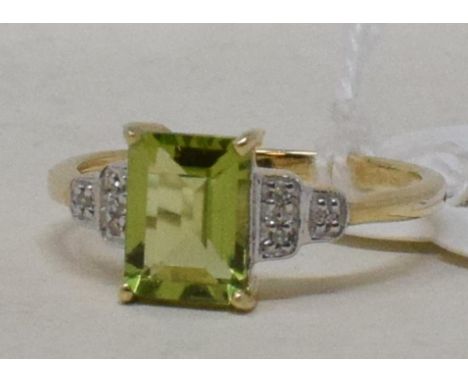 A 9ct gold, peridot and diamond shoulder ring

 