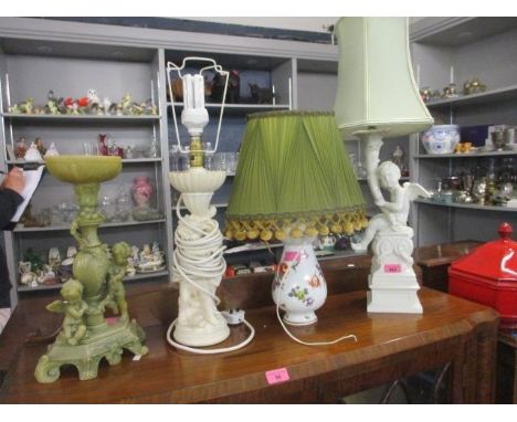 A group of four table lamps to include a German floral bone china lamp with vintage green and tasselled shade 