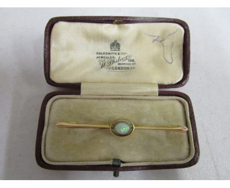 A 9ct yellow and opal set bar brooch, in a M Philcox of London box, total weight, 3.2g 