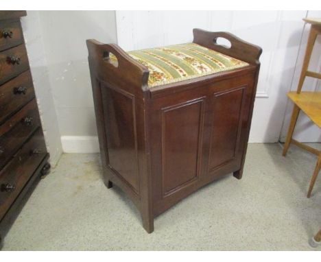 An early 20th century mahogany organ stool 