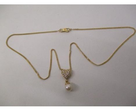 A gold coloured metal necklace with heart shaped pendant, set with diamonds and a pearl on a fine chain, stamped 18ct, 4.9g t
