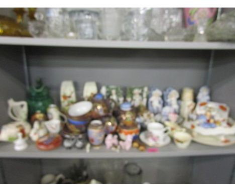 A selection of ceramic ornaments, animals and part tea sets to include Wade, Disney, Belleek, crested china and a Japanese te