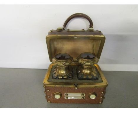 A 19th century Grand Tour, French, leather clad scent bottle casket with domed top and handle, gilt brass studwork and mounte