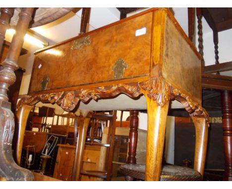 Mid 20th Century figured walnut side cabinet with hinged cover and fall front above a carved frieze and cabriole supports tog