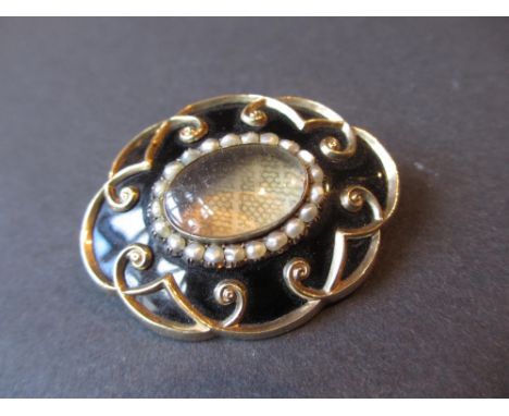 19th Century yellow metal enamel and seed pearl decorated oval memorial brooch