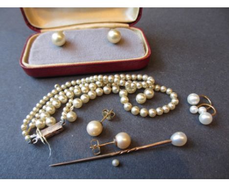 Single row graduated cultured pearl necklace with paste set silver clasp together with three pairs of cultured pearl earrings