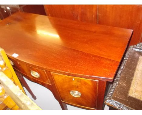 Small 19th Century mahogany bow front sideboard in George III style, the centre drawer flanked by a cupboard door and cellare