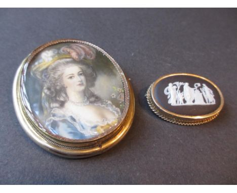 19th Century oval gilt metal pendant brooch inset with a miniature portrait of a lady on ivory, together with a Wedgwood blac