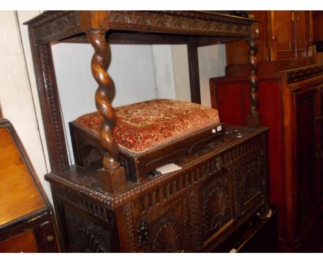 Carved oak side cabinet, the canopy top with barley twist supports above a three panel box base with cupboard doors (alterati